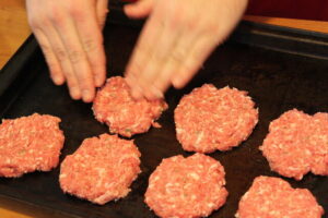 Shaping and cooking sausage meat patties.