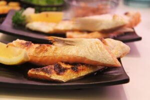 Searing fish fillets.