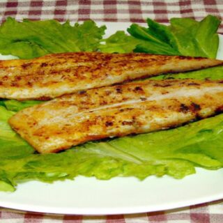 Plated Grilled Fish Fillets with Lemon and Herbs