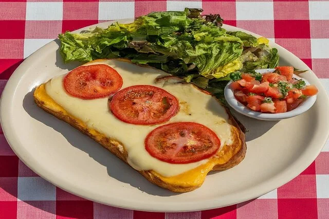 Plated cheese on toast with salad