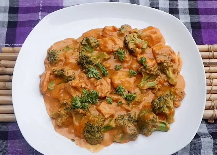 Plated Creamy Salmon with Broccoli in a Savoury Tomato Sauce